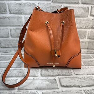 Michael Kors Medium Orange Pebbled Leather Belted Medium Bucket Crossbody Bag